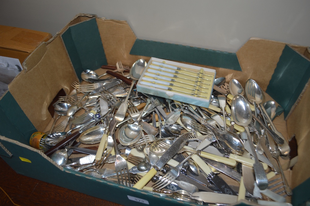 A box of various stainless steel cutlery