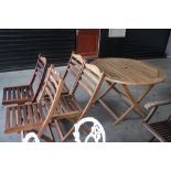 An Alexandra Rose teak garden table; and four matc