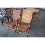 A pair of teak folding garden chairs