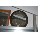 A bevel edged oval framed wall mirror