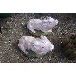 A pair of concrete garden ornaments in the form of