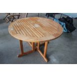 A folding teak garden table