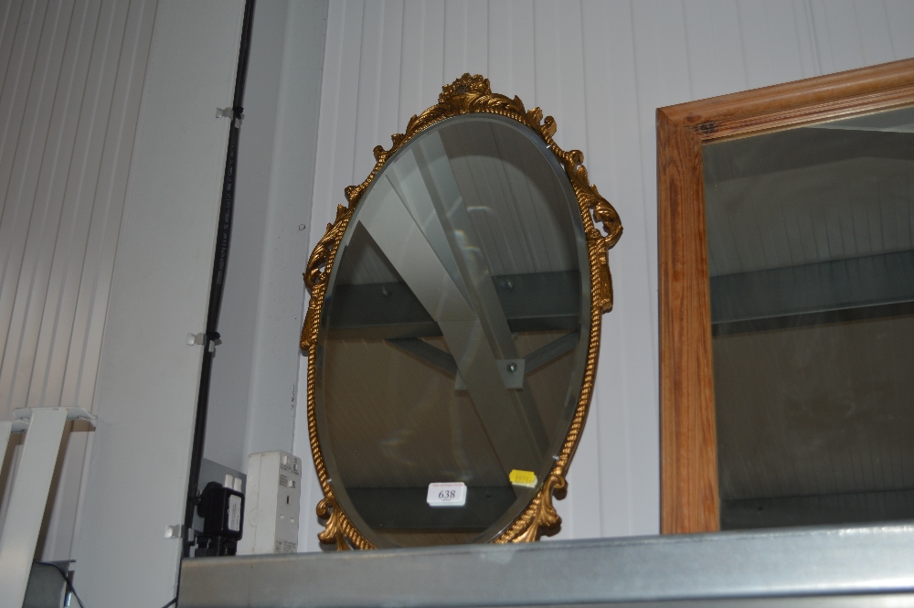 An oval bevel edged wall mirror