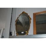 An oval bevel edged wall mirror
