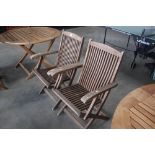 A pair of folding teak garden chairs