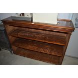 A mahogany open fronted bookcase