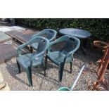 A folding plastic table with a set of three chairs