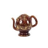 A Victorian "Cadogan" teapot, brown glazed heightened with gilt floral decoration, 22cm high