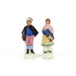 A pair of Victorian Staffordshire figures, depicting a highland couple, 33cm high