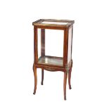 A small 19th Century walnut and gilt metal mounted vitrine, having brass gallery top around a