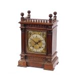 A Victorian walnut cased chiming mantel clock, having brass spandril dial and steel chapter ring,