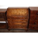 A Georgian oak bureau, the fall front opening to reveal an interior arrangement of drawers and