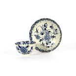 A Worcester blue and white tea bowl and saucer, decorated foliage and butterflies, crescent mark