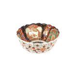 A large 19th Century Imari bowl, decorated in traditional palate with scalloped border heightened in