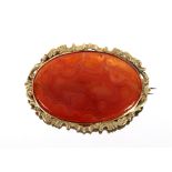 A vintage yellow metal mounted oval agate brooch