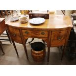 A George IV mahogany bow fronted sideboard, fitted central drawer flanked by cupboard and deep