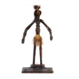 A carved wooden Ethnic figure of a primitive man, 76cm high overall