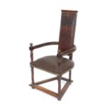 A walnut Caquetoire chair, having Spanish leather embossed upholstery, the arms with fluted