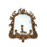 A 19th Century gilt framed ornate wall mirror, fitted triple candle sconces within foliate