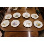 A Derby part dessert set, comprising a pair of comports and five plates, having profuse floral