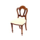 A set of six Victorian mahogany  balloon back dining chairs, upholstered stuff over seats raised