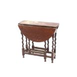 An oak gate leg tea table, raised on barley twist supports, with rounded drop leaves, 70cm