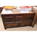 An Antique oak mule chest, the hinged lid above triple panel front, two drawers below raised on