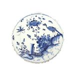 An 18th Century Delft charger, decorated with birds and insects amongst foliage, 32.5cm dia.