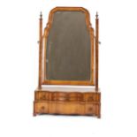 An 18th Century style walnut swing toilet mirror, the shaped plate raised above a serpentine stepped