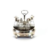 A George IV silver cruet, containing various bottles, some AF, London 1826