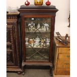 A mahogany Chippendale style display cabinet, having blind fret decoration, the fabric lined shelves