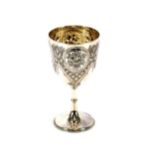 A Victorian silver goblet, having rich engraved foliate and fruit decoration on tapering stem and