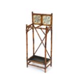 A late Victorian bamboo stick stand, with tiled back and brass mounts, 40cm wide x 98cm high
