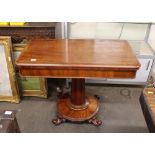 A Victorian mahogany card table, the rectangular swivel top raised on a cylindrical column and