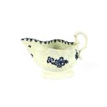 An 18th Century English blue and white porcelain sauce boat, of baluster triangular shape, decorated