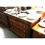 A Continental mahogany commode, surmounted by a grey marble top, blind frieze drawer and three