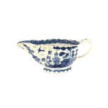 An 18th Century blue and white porcelain English sauce boat, decorated in the Chinese manner, of