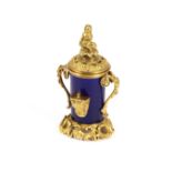 A 19th Century French porcelain and ormolu rise and fall ink stand, the lid surmounted by a seated