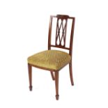 A pair of Edwardian inlaid mahogany side chairs, having pierced lattice backs, upholstered stuff-