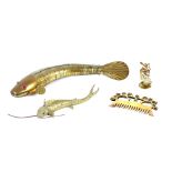 An Oriental brass articulated fish, 25cm long; a brass model of a carp; ethnic brass comb etc. (4)