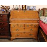 An 18th Century oak bureau, having stepped interior arrangement of pigeon holes and drawers above