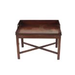 A mahogany butler's tray, the shaped gallery with integral handles raised on a chamfered legs,