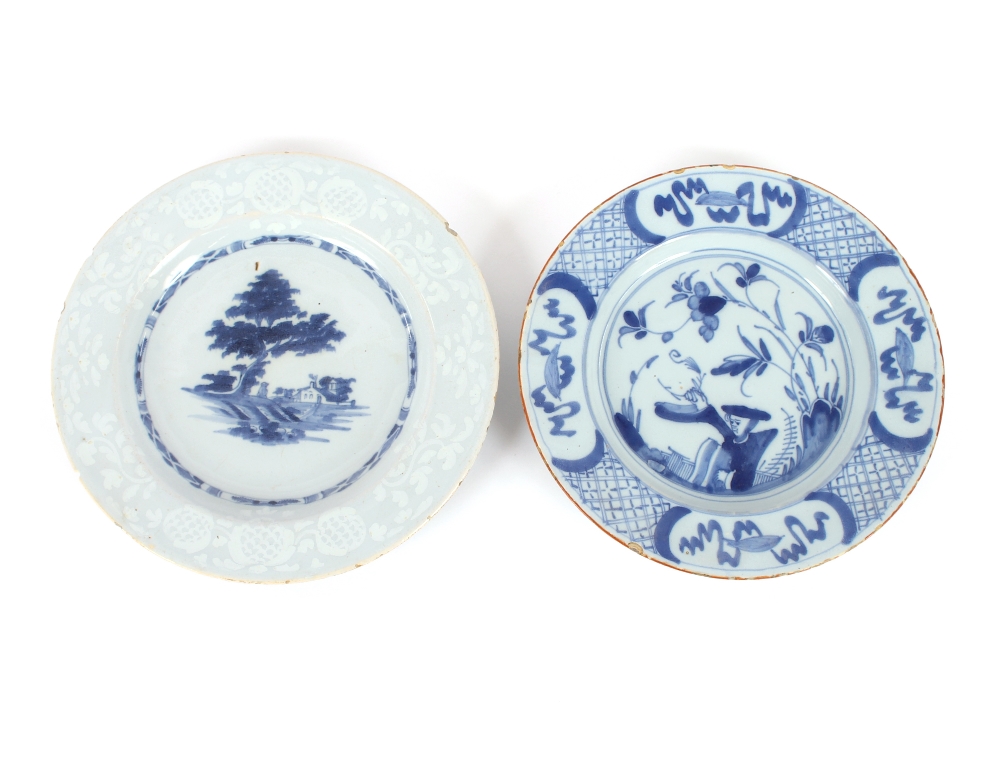 A Delft plate, decorated with a figure holding a branch; and another similar decorated with rural