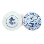 A Delft plate, decorated with a figure holding a branch; and another similar decorated with rural