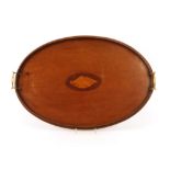 An Edwardian mahogany oval tea tray, with conch shell inlay flanked by brass carrying  handles