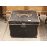 A small black canvas and leather bound travelling trunk, the lid with carrying handle, 46.5cm wide x