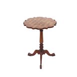 A Victorian mahogany occasional table, the shaped top with inlaid games board raised on a baluster