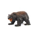 A Black Forest style carved bear ornament, 40cm long