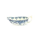 An 18th Century blue and white porcelain oval cream boat, decorated in the Chinese manner of