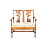 A Chippendale design double chair back settee, having needlepoint upholstered drop in seat raised